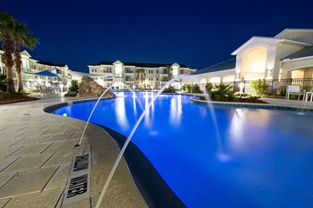 Resort-style swimming pool at night